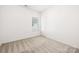 Bright bedroom features a window and neutral carpeting, ready for personalization at 327 Lincoln Sw St, Concord, NC 28025