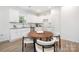 Eat-in kitchen with modern appliances, stylish wooden table, and bright lighting at 327 Lincoln Sw St, Concord, NC 28025