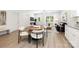 Open-concept living area with modern dining set, sleek seating, and bright natural light at 327 Lincoln Sw St, Concord, NC 28025