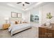 Bright and serene main bedroom with soft lighting, neutral tones, and a large window at 327 Lincoln Sw St, Concord, NC 28025