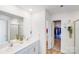 Stylish bathroom featuring double sinks, a large mirror, and a walk-in closet at 3286 Shining Rock Sw St, Concord, NC 28027