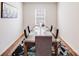 Formal dining room with a dark wooden table set for six, featuring modern decor and a bright, airy ambiance at 3286 Shining Rock Sw St, Concord, NC 28027