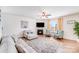 Comfortable living room with fireplace, TV, ceiling fan, and natural light from the window at 3286 Shining Rock Sw St, Concord, NC 28027