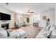 Cozy living room featuring a fireplace, hardwood floors, and a view of the kitchen at 3286 Shining Rock Sw St, Concord, NC 28027