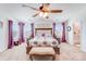 Spacious main bedroom with a ceiling fan, decorative pillows, and an ensuite bathroom at 3286 Shining Rock Sw St, Concord, NC 28027