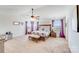 Well-lit main bedroom features carpeted floors, a bench, ceiling fan, and bedside tables at 3286 Shining Rock Sw St, Concord, NC 28027