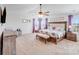 Spacious main bedroom with carpet, ceiling fan, decorative pillows, and lots of natural light at 3286 Shining Rock Sw St, Concord, NC 28027