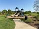 Community playground area with mulch base, slides and walking path at 3286 Shining Rock Sw St, Concord, NC 28027