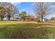 View of backyard with mature trees and classic brick home at 3320 28Th Ne St, Hickory, NC 28601