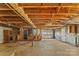 Unfinished basement with exposed wood ceiling and concrete floors with a garage door at 3320 28Th Ne St, Hickory, NC 28601