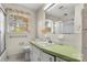Retro bathroom featuring white tile, green countertops, and natural light at 3320 28Th Ne St, Hickory, NC 28601