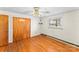 This bedroom features hardwood floors, a ceiling fan, a closet, and a window view at 3320 28Th Ne St, Hickory, NC 28601