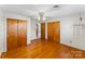 This bedroom features hardwood floors, a ceiling fan, and large closets at 3320 28Th Ne St, Hickory, NC 28601
