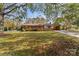 Charming brick ranch-style home with a covered carport and well-maintained front yard and mature trees at 3320 28Th Ne St, Hickory, NC 28601