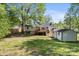 Spacious backyard features a deck, storage shed, and mature trees, offering privacy and space at 3715 Dallas High Shoals Hwy, Dallas, NC 28034