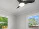 Bedroom with large windows and updated ceiling fan showing natural light and outdoor view at 3715 Dallas High Shoals Hwy, Dallas, NC 28034