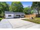 Exterior view of a cozy home with a spacious driveway and well-maintained yard at 3715 Dallas High Shoals Hwy, Dallas, NC 28034