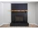 Close-up of a painted brick fireplace with a rustic wooden mantle and black iron details at 3715 Dallas High Shoals Hwy, Dallas, NC 28034