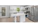 Modern kitchen boasts white cabinetry, stainless steel appliances, and center island at 3715 Dallas High Shoals Hwy, Dallas, NC 28034