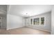 Bright living room with large windows, light wood flooring and a modern chandelier at 3715 Dallas High Shoals Hwy, Dallas, NC 28034
