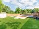 Lush backyard featuring a pool area, and mature trees at 4303 Greenhaven Ln, Gastonia, NC 28056