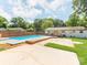 Backyard featuring a pool, deck area, and some lawn at 4303 Greenhaven Ln, Gastonia, NC 28056