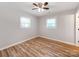 Cozy bedroom with neutral paint, wood-look flooring, a ceiling fan, and natural light at 4303 Greenhaven Ln, Gastonia, NC 28056