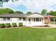 Charming single-story home with American flag, manicured lawn, and inviting front entrance at 4303 Greenhaven Ln, Gastonia, NC 28056