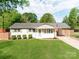 Charming single-story home with a well-manicured lawn and classic white exterior at 4303 Greenhaven Ln, Gastonia, NC 28056