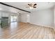 Spacious open-concept living area with new laminate floors, modern ceiling fans, and backyard access at 4303 Greenhaven Ln, Gastonia, NC 28056