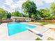 Backyard pool surrounded by a wooden deck and ample green space at 4303 Greenhaven Ln, Gastonia, NC 28056