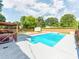 Sparkling pool with wooden deck, wooden structure, and landscaped backyard, ideal for relaxation at 4303 Greenhaven Ln, Gastonia, NC 28056