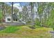 Expansive backyard featuring a retaining wall, steps leading to the house, and mature trees at 438 Wonderwood Dr, Charlotte, NC 28211