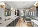 Spacious bathroom with double vanity, marble accents, and a modern glass shower at 438 Wonderwood Dr, Charlotte, NC 28211
