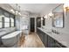 Bright bathroom featuring marble accents, a soaking tub, and stylish fixtures at 438 Wonderwood Dr, Charlotte, NC 28211