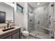 Modern bathroom featuring marble accents, a stylish vanity, and glass enclosed shower at 438 Wonderwood Dr, Charlotte, NC 28211