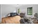 Spacious Bedroom with hardwood floors, stylish gray furniture, and a cozy beanbag chair at 438 Wonderwood Dr, Charlotte, NC 28211