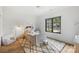 Bright bedroom features a white woven bed, plush rug, and natural light from a large window at 438 Wonderwood Dr, Charlotte, NC 28211