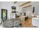 Stylish dining area featuring a modern chandelier and an open view of the kitchen and living space at 438 Wonderwood Dr, Charlotte, NC 28211