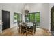 Bright dining area with large windows and a rustic wood table perfect for gatherings at 438 Wonderwood Dr, Charlotte, NC 28211