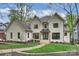 Elegant two-story home showcasing a beautiful brick exterior, manicured lawn and walkway at 438 Wonderwood Dr, Charlotte, NC 28211