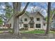 Elegant two-story home showcasing a beautiful brick exterior, manicured lawn and walkway at 438 Wonderwood Dr, Charlotte, NC 28211