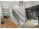 Elegant foyer boasting hardwood floors, a staircase, and views of the office space at 438 Wonderwood Dr, Charlotte, NC 28211
