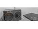 Modern laundry room showcasing gray front load washer and dryer at 438 Wonderwood Dr, Charlotte, NC 28211