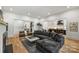 Spacious living room featuring a large sectional sofa, hardwood floors, and ample natural light at 438 Wonderwood Dr, Charlotte, NC 28211