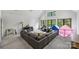 Spacious living room with vaulted ceiling, large windows, and comfortable seating at 438 Wonderwood Dr, Charlotte, NC 28211