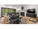 Cozy living room with a fireplace, a large sectional sofa, and access to outdoor spaces at 438 Wonderwood Dr, Charlotte, NC 28211