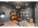 Elegant office with dark walls, custom shelving, and a large window providing natural light at 438 Wonderwood Dr, Charlotte, NC 28211