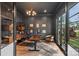 Sophisticated office with dark walls, custom shelving, and a large window providing natural light at 438 Wonderwood Dr, Charlotte, NC 28211