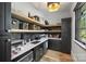 Well-organized pantry with black cabinets, open shelves, and ample storage space at 438 Wonderwood Dr, Charlotte, NC 28211